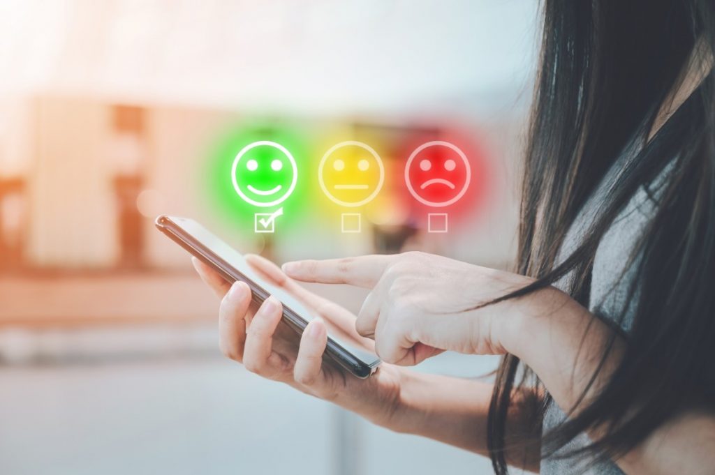 Personne donnant son avis de satisfaction sur smartphone