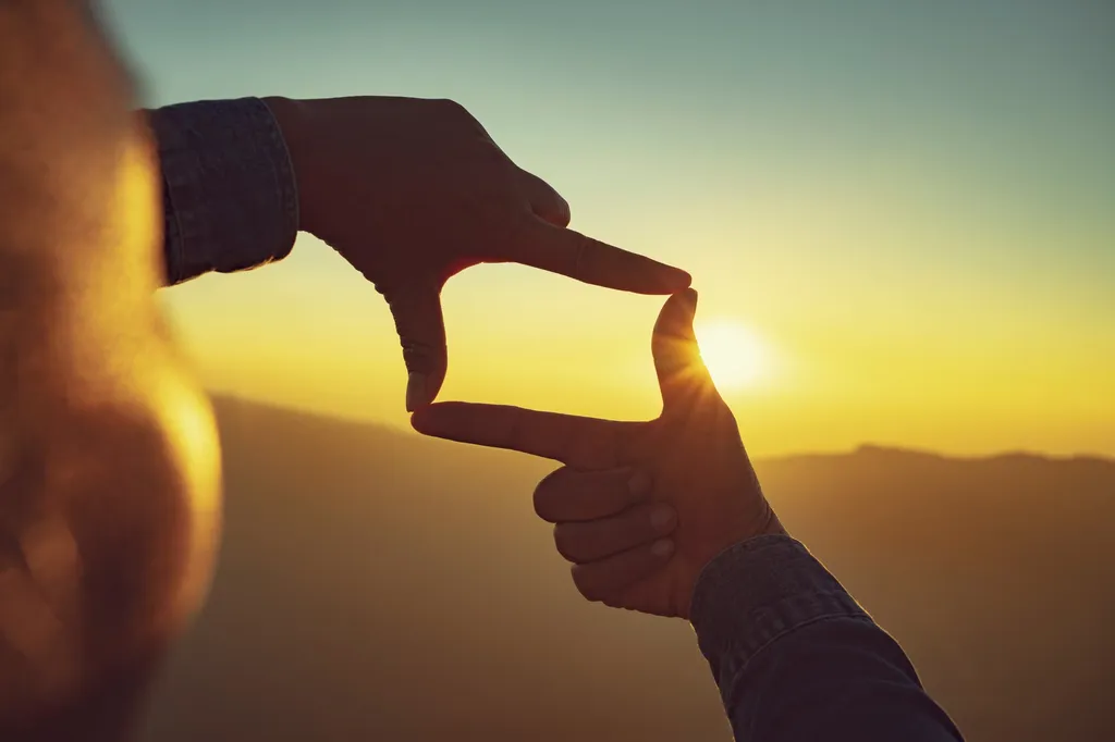 Mains cadrant l'horizon au soleil couchant, prendre du recul et avancer sereinement