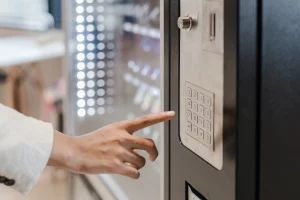 Main saisissant un code sur le clavier d'une machine, illustrant la remise en marche du Référentiel National Qualité